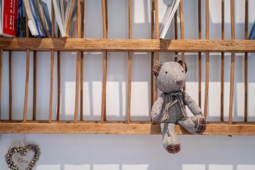 a small teddy bear is sitting in a crib at Haus Karin living in Brixen