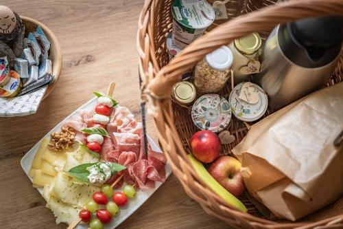 a basket full of food on a wooden table at Haus Karin living in Brixen