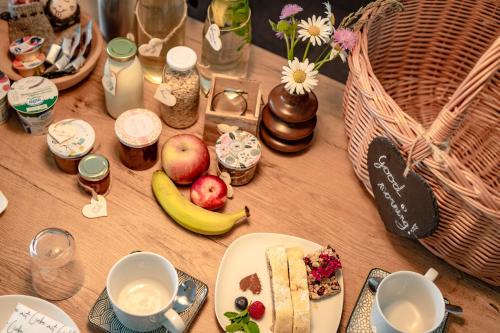 a wooden table with food and fruit on it at Haus Karin living in Brixen