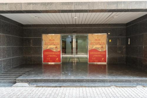 a building with two signs in front of a building at Royal Tulip Studio in Sharjah