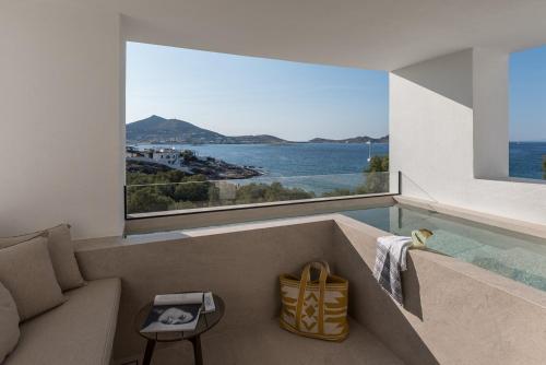 a living room with a view of the water at Hotel Senia - Onar Hotels Collection in Naousa