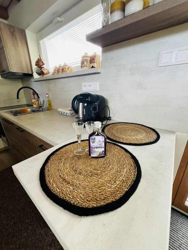 a kitchen counter with two wine glasses on it at Tiny house Podbieľanská Archa in Podbiel