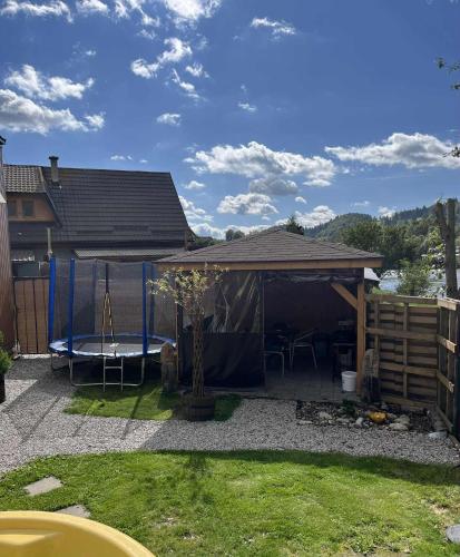 a backyard with a gazebo with a swing at Tiny house Podbieľanská Archa in Podbiel