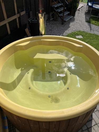 a jacuzzi tub with a sign in the middle at Tiny house Podbieľanská Archa in Podbiel