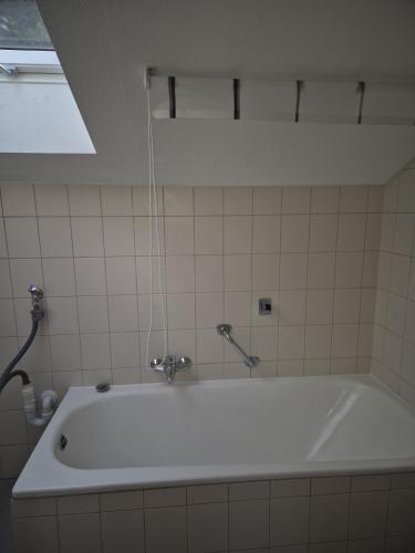 a white bath tub in a bathroom at Ferienwohnung Ausblick in Bad Wildbad