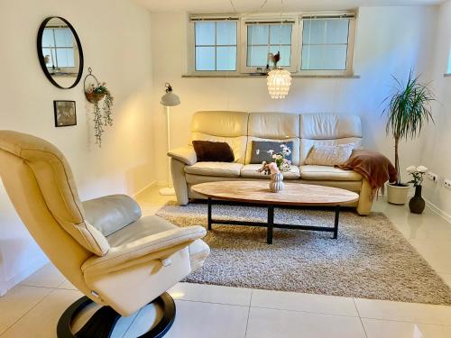 a living room with a couch and a table at Møllehusets lejligheder i Ikast tæt ved Herning, Silkeborg og Århus in Ikast