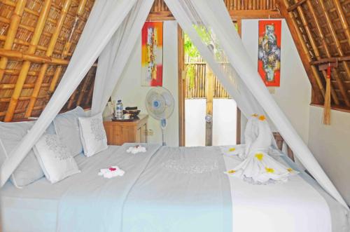 Кровать или кровати в номере Lagoona Beach Bungalows - Eco Stay