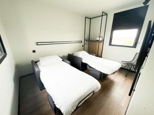 a hospital room with two beds and a chair at Ibis Lunel Petite Camargue in Lunel