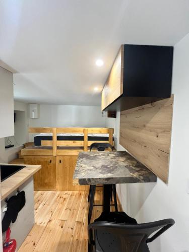 a kitchen with wooden floors and a counter top at 18 m studio in Orelle 73140 in Orelle