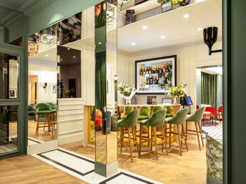 a room with a bar with green stools at Mercure Paris Gare De Lyon Opera Bastille in Paris