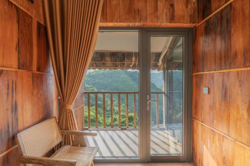 a room with a balcony with a glass door at Gia Trang Heian Hoa Binh in Hòa Bình