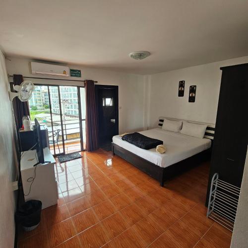 a bedroom with a bed and a television in it at Secrets - Pattaya in Pattaya