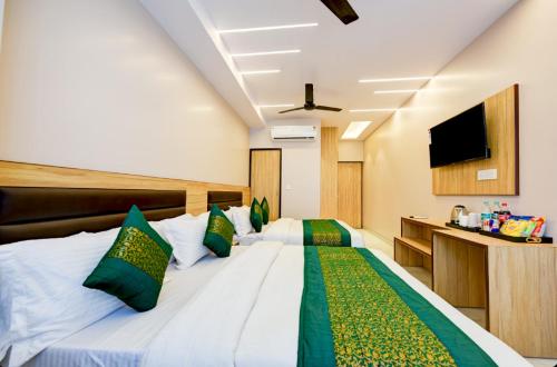 a bedroom with two beds and a flat screen tv at Hotel Express 66 Just a Minute Away From New Delhi Railway Station Main Road in New Delhi