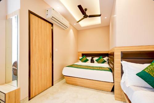 a bedroom with a bed and a wooden door at Hotel Express 66 Just a Minute Away From New Delhi Railway Station Main Road in New Delhi
