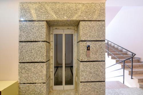 a building with a glass door and a staircase at Hotel Express 66 Just a Minute Away From New Delhi Railway Station Main Road in New Delhi