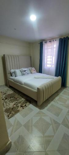 a large bed in a bedroom with a window at Leisure homes Narok in Narok