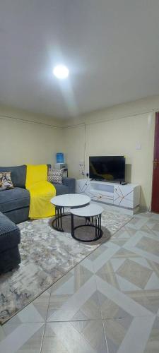 a living room with a couch and a table at Leisure homes Narok in Narok