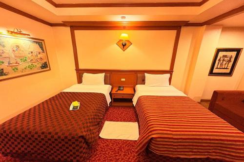 Postel nebo postele na pokoji v ubytování Taksila Hotel