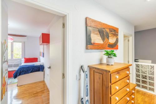 a bedroom with a bed and a dresser in a room at Gran casa de campo ideal para familias en Navarra in Larrasoaña