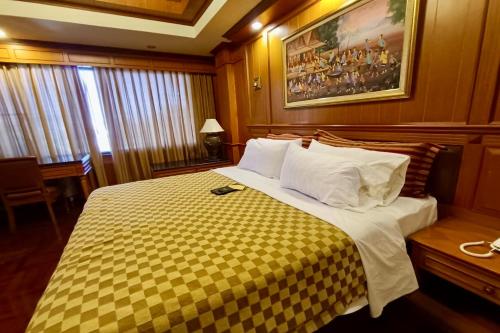 Postel nebo postele na pokoji v ubytování Taksila Hotel