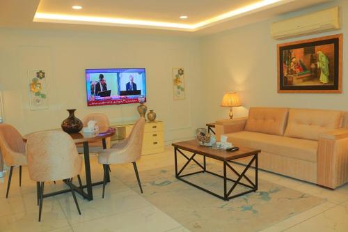 a living room with a couch and a table at Bahria Sunrise Apartments in Rawalpindi