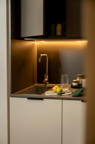 a kitchen with a sink and a plate of fruit at The Wellington Glasgow by Adina in Glasgow