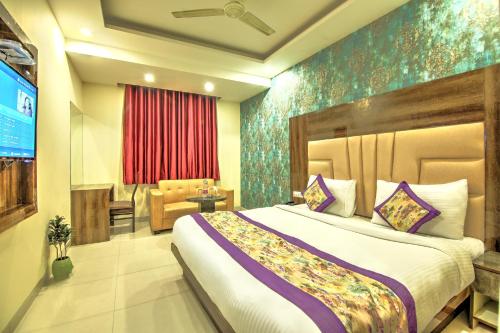 a bedroom with a large bed in a room at Smart Lax Hotel Free-Airport Pick Up in New Delhi