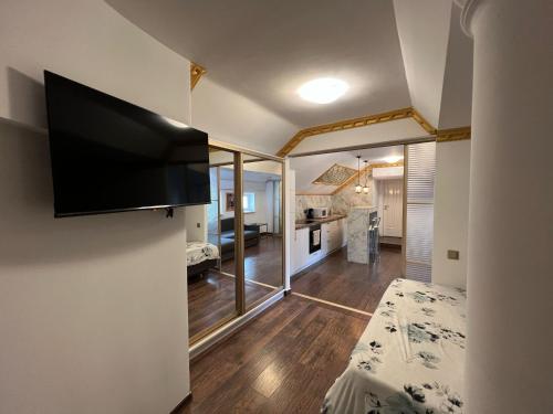 a room with a flat screen tv on a wall at Central Park Street Apt in Chişinău