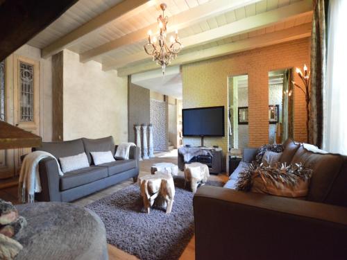 a living room with couches and a dog in the middle at Group Stay with Private Pool and Sauna in Alphen