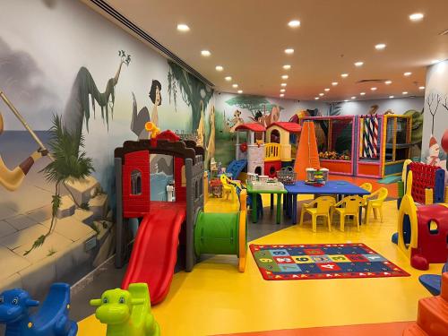 a childrens play room with a playground and play equipment at Chamada Girne Hotel Spa and Casino in Kérynia