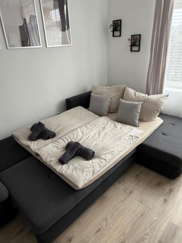 a large bed with two pairs of shoes on it at Ferienwohnung - schönes Heim Li-Apartments in Pforzheim
