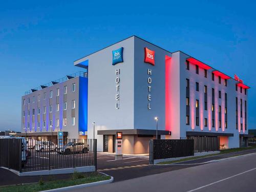 a large building with red lights on the side of it at ibis Sens in Sens