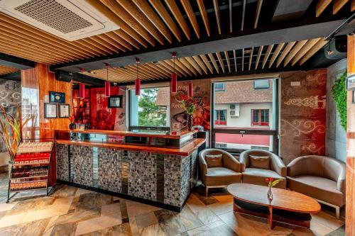 a bar with chairs and a table in a room at H9 Hotel Nine Ulaanbaatar in Ulaanbaatar