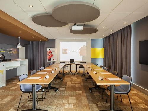 a conference room with a long table and chairs at ibis Sens in Sens