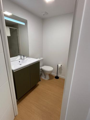 a bathroom with a sink and a toilet at Sweetly Bordeaux Mérignac Aeroparc in Mérignac