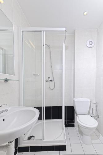 a bathroom with a shower and a toilet and a sink at Penzion Hendrych in Vrchlabí