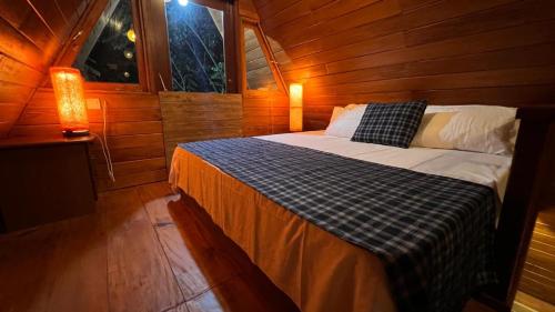 a bedroom with a bed in a wooden cabin at Siri Villa Cabana Habaraduwa in Habaraduwa
