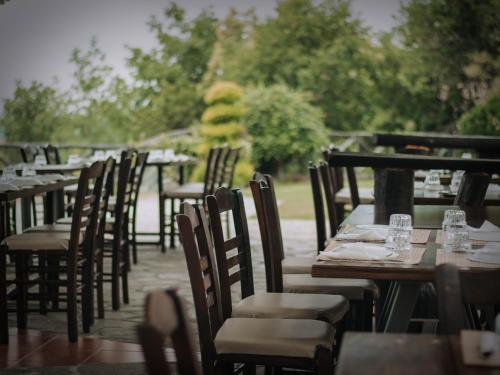 a row of tables and chairs on a patio at Μαγεμένο Δάσος Apartments in Neokhórion