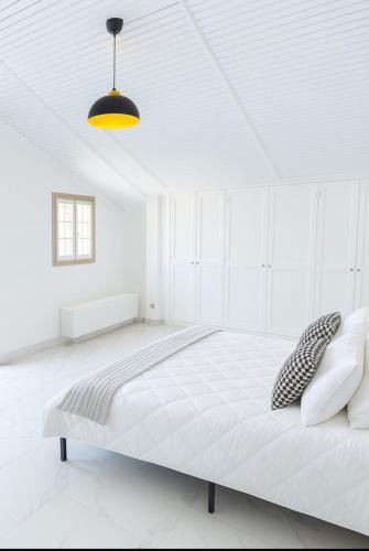 a white bedroom with a large bed in a room at Premium house in Mougins with Private Tennis in Mougins