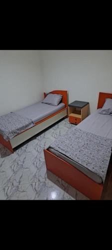 two beds in a room with two beds sidx sidx sidx at Dar Nour in Douz