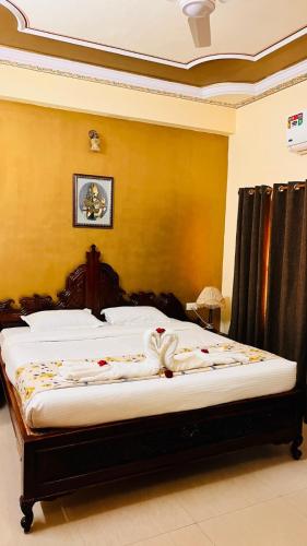 a bedroom with a large bed with white sheets at Hotel Master Paradise, Pushkar, Rajasthan , INDIA in Pushkar