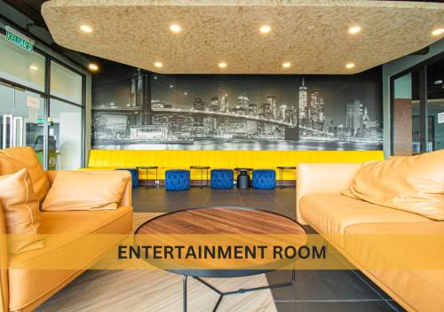 a room with two couches and a wall with an enrichment room at Neu Suites, 4 - 7 Pax, 4 Mins to KLCC in Kuala Lumpur