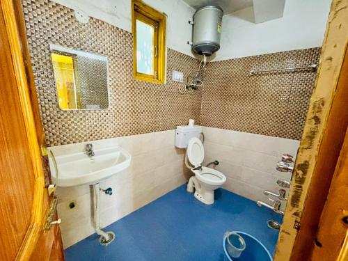 a bathroom with a toilet and a sink at Airship Manali - A Mountain View Hotel in Manāli