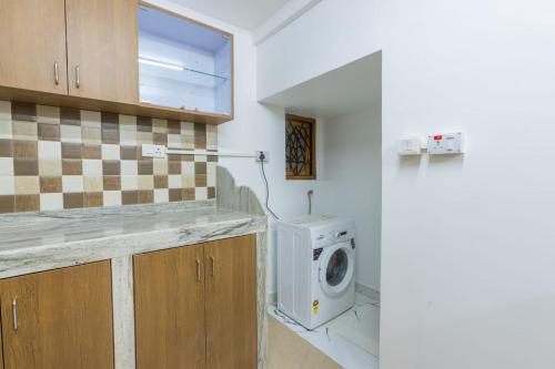 a laundry room with a washing machine in it at 4Bedroom Villa With shared pool in Nerul