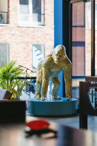 a statue of a monkey sitting on a table at The Social Hub Groningen in Groningen