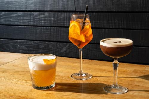 two glasses of drinks sitting on a wooden table at The Social Hub Groningen in Groningen