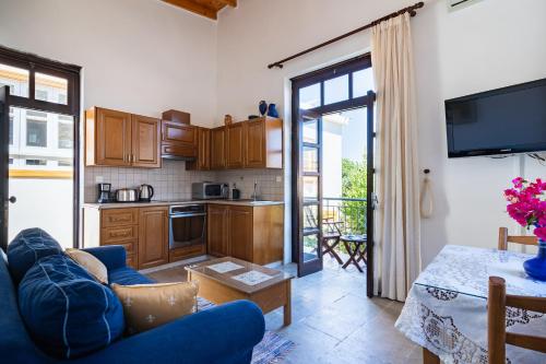 a living room with a blue couch and a kitchen at Aunt Maria's in Pano Lefkara