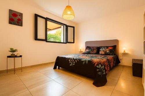 a bedroom with a bed and a window at Eau clair de lune - Vincendo in Saint-Joseph