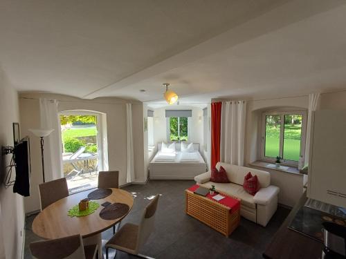 a living room with a couch and a table at Plantagengut Hosterwitz in Dresden