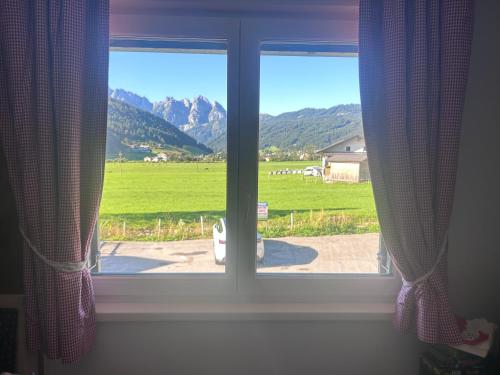 a window with a view of a field at De Jutter Edelweiss in Gosau